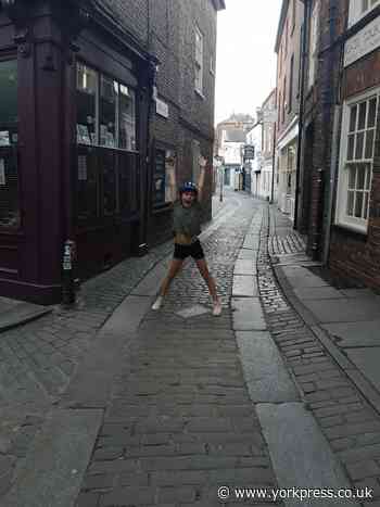 Residents cycle around York's deserted streets