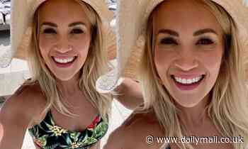 Carrie Underwood flashes her toned abs ahead of a pool day