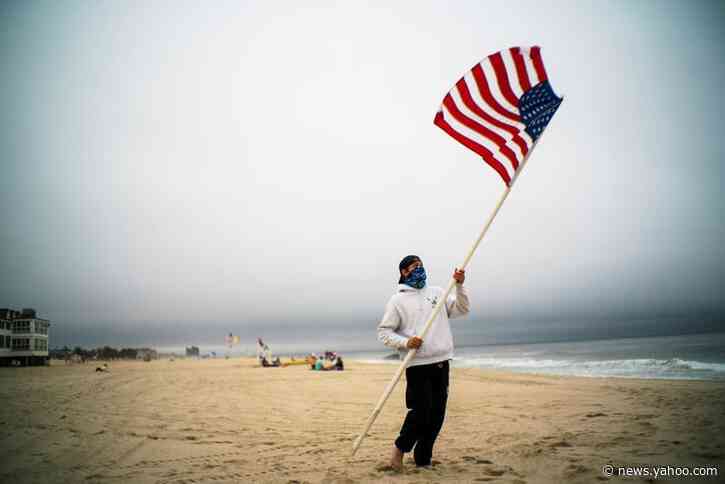 COVID-19 distancing compels shifts at the beach on crowded U.S. Memorial Day weekend