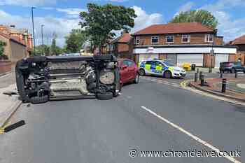 Driver has lucky escape after car flips on side in two-vehicle crash