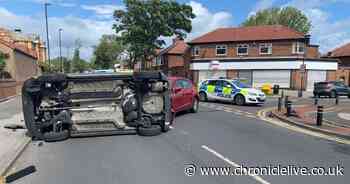 Driver has lucky escape after car flips on side in two-vehicle crash