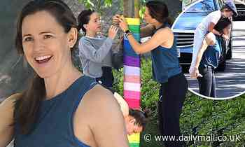 Jennifer Garner gives Samuel, eight, a piggyback ride after decorating her home for Memorial Day