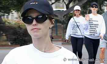 Katherine Schwarzenegger hides her burgeoning baby bump as she twins with mom Maria Shriver