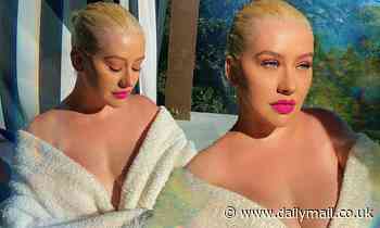 Christina Aguilera exposes cleavage in her bathrobe during 'cozy and calm' Memorial Day Weekend