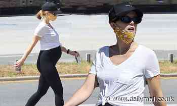 Katherine Schwarzenegger shows off her baby bump as she goes for a family stroll with Maria Shriver