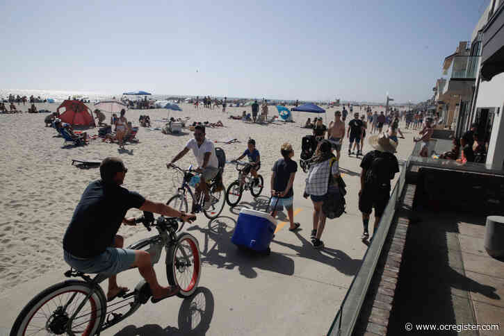 At So Cal beaches, heat, holiday and eased rules put more people on the sand