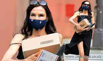 Famke Janssen, 55, can barely stay covered as a strap falls off her dress
