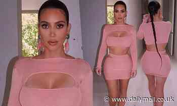 Kim Kardashian shows off her curves in a VERY tight-fitting ensemble