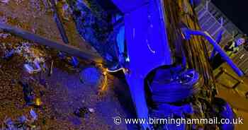 Cops slam 'irresponsible' drivers as Audi flipped and impaled in city smash