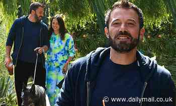 Ben Affleck flashes a smile beneath his newly darkened beard