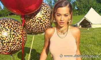 Rita Ora goes for a summer festival vibe as she saunters through the grass with balloons