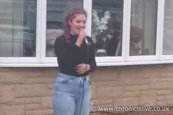 See teen of key worker family singing to neighbours at Clap for Carers
