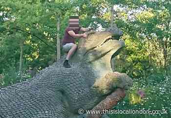 Men caught in picture climbing Crystal Palace Dinos