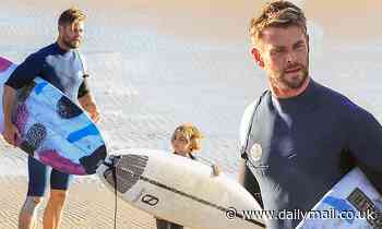 Chris Hemsworth enjoys an after-school surf with one of his young sons in Byron Bay - Daily Mail