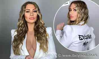 Love Island's Shaughna Phillips flaunts her ample assets in a plunging white power suit