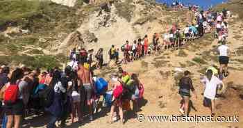 Police close packed beach as helicopters land at the scene