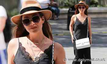 Myleene Klass nails sophisticated chic in a black silk top and a fedora