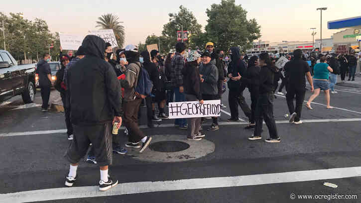 Protesters in Santa Ana throw fireworks and explosives at police, officers declare an unlawful assembly