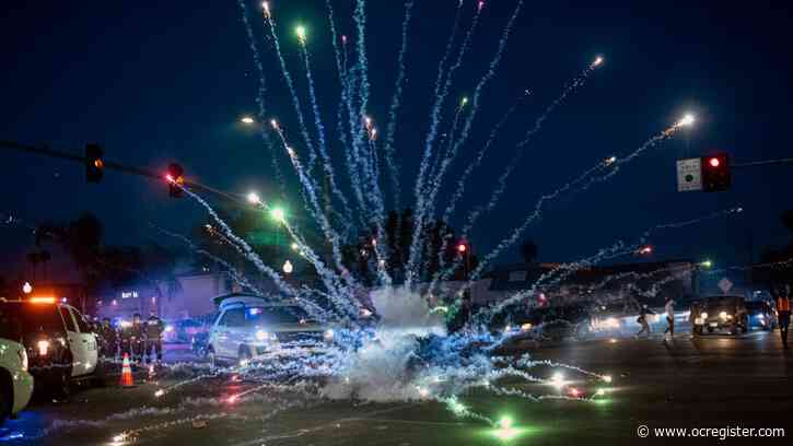 Protesters in Santa Ana throw rocks, fireworks at police; officers respond with tear gas and rubber bullets