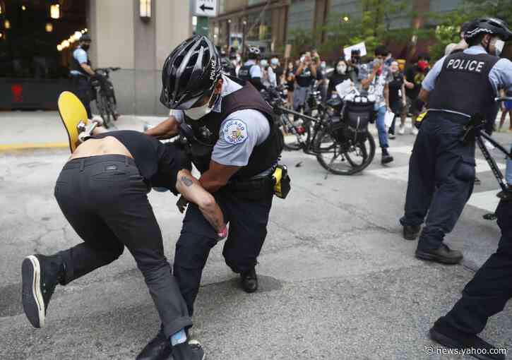Squad cars damaged, protesters struck with batons in Chicago
