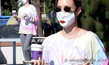 Whitney Port wears a funny face mask emblazoned with red lips as she steps out for a coffee