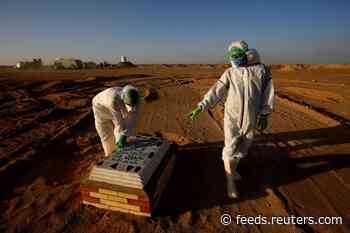 Iraqi militiamen drop guns to dig graves for coronavirus victims