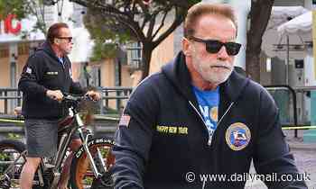 Arnold Schwarzenegger rides his bike around Santa Monica and stops to look at the vandalized stores