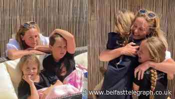 Watch: Medic mum reunited with daughters after nine weeks apart