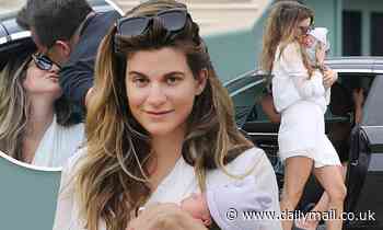 Rachel McCord cradles her newborn son, Richard, and plants a kiss on husband, Rick Schirmer, in LA