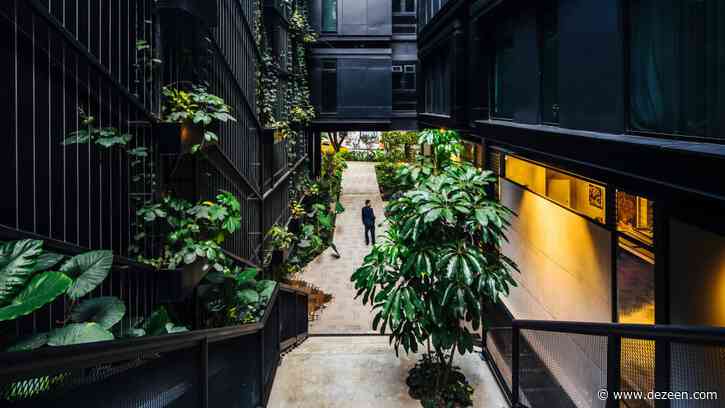 Plants cover grey steel of Hotel Click Clack Medellín by Plan:b Arquitectos