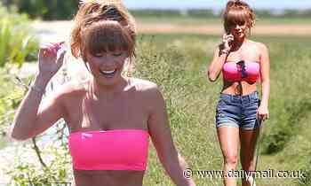 Summer Monteys-Fullam shows off her washboard abs in a neon pink crop top on dog walk