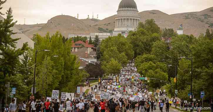 Hundreds of protesters march down State Street on Thursday; city and county leaders kneel as they walk by