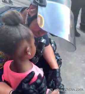 Viral video shows heartwarming moment as cop comforts Houston girl at George Floyd rally - Chron
