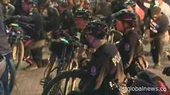 ‘This is what solidarity looks like’: Edmonton police, protesters take a knee together