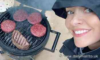 Holly Willoughby dons a black rain mac as she enjoys a BBQ feast with her family