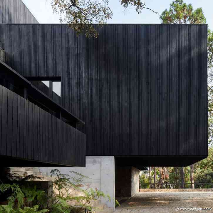 Charred wood and stone create dark house Casa Di-Dox by Magaldi Studio