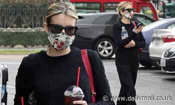 Emma Roberts picks up a double dose of caffeine as she covers up in floral mask for errands run