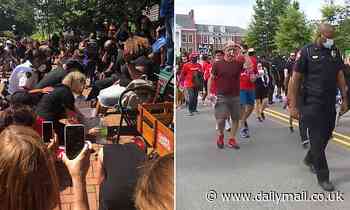 White police officers and community members wash feet of black faith leaders at protest