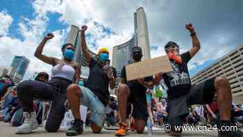 Toronto police officers take a knee as thousands protest anti-Black racism - CP24 Toronto's Breaking News