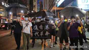 Hong Kong protesters defy police warnings and march on key anniversary