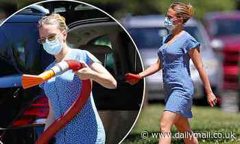 Scarlett Johansson cuts a stylish figure in blue and white dress while tackling her to-do list
