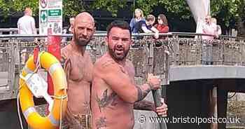 Men try to get statue out of harbour with pole