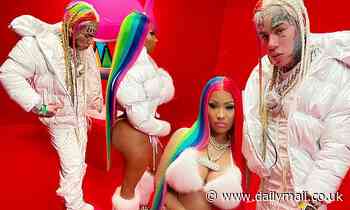 Nicki Minaj covers her midsection adding more fuel to pregnancy rumors