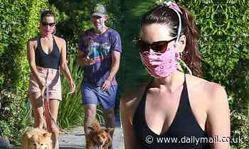 Aubrey Plaza wears a plunging halter top as she and Jeff Baena take their dogs out for a jaunt