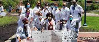 Medical workers, students take a knee to show solidarity with community, end racism - The South End