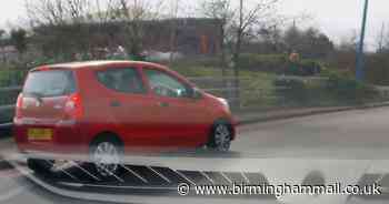 Watch hair-raising moment driver pulls out and stops on busy roundabout