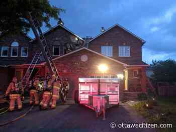 Attic fire in unoccupied rowhouse unit under investigation