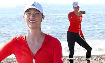Karlie Kloss flaunts her svelte physique while she FaceTimes with a pal in Malibu