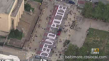 Protesters March In Downtown Baltimore; Paint ‘Defund The Police’ On Gay Street Outside City Hall - CBS Baltimore