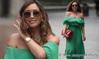 Myleene Klass looks radiant in a strapless green dress and red Chanel tote